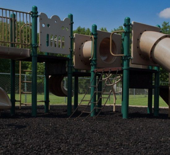 Play structure over black rubber mulch