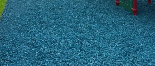 Close view of vivid blue rubber mulch surface