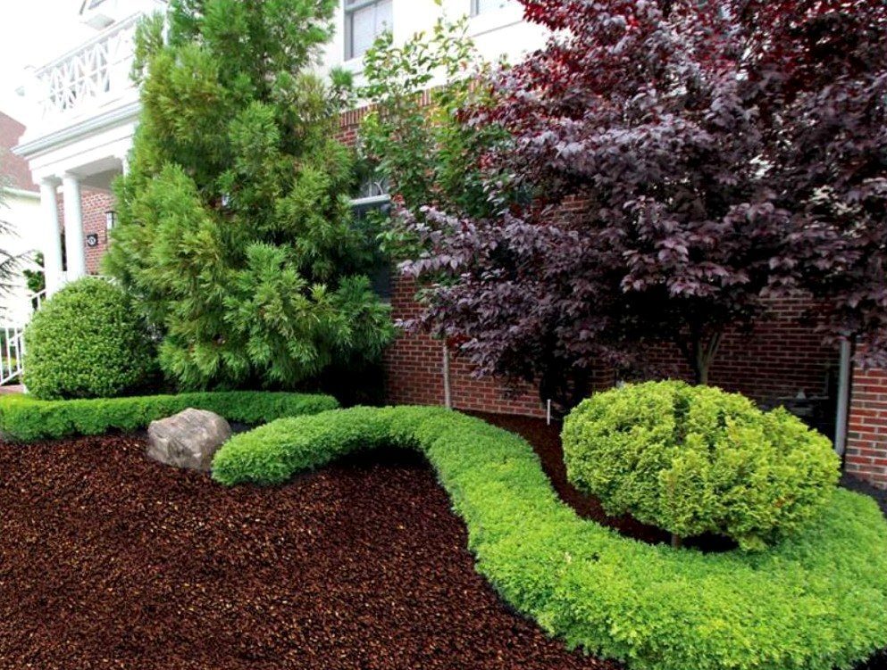 Brown rubber mulch in a residential landscape bed