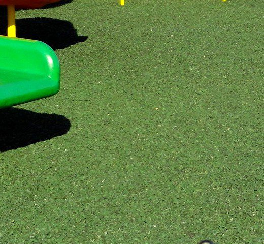 Close view of green rubber mulch surface
