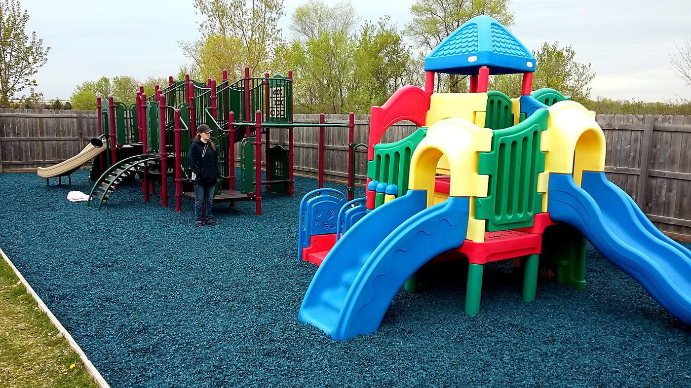 Play structure with slides and climbers on a rubber mulch surface