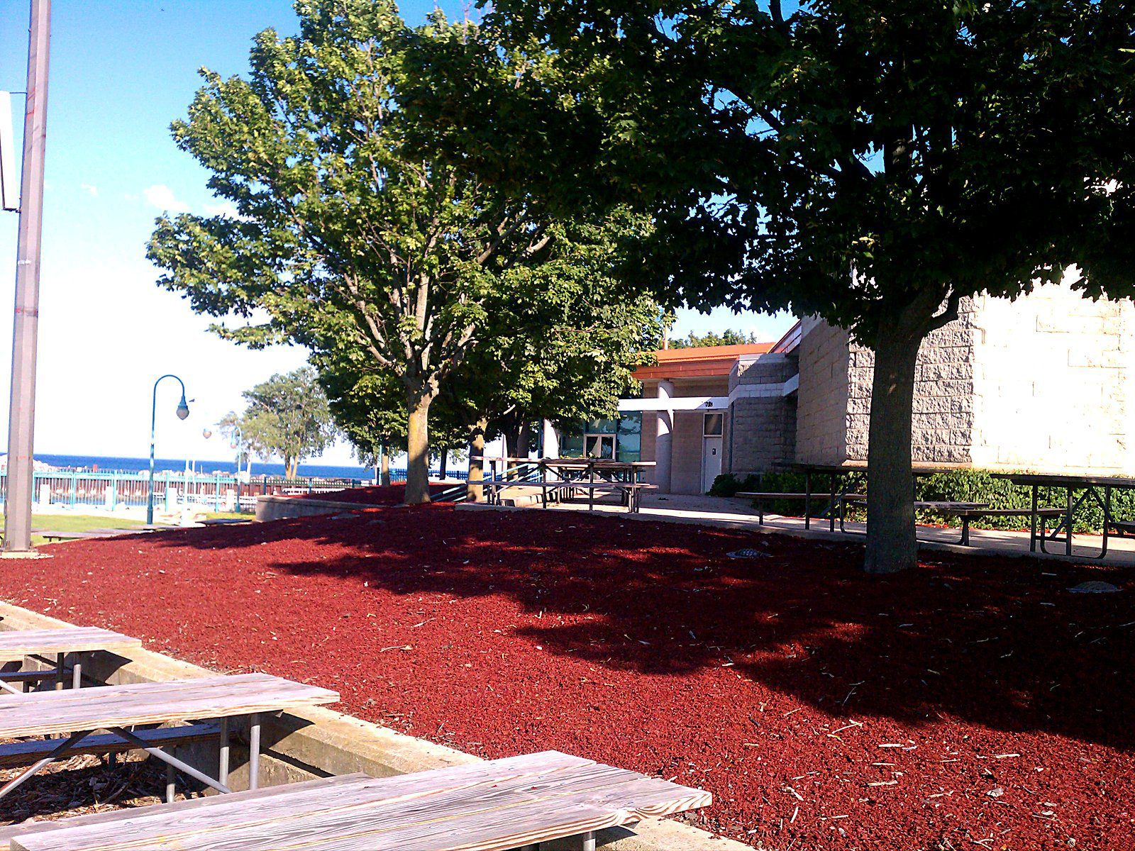 Play area bordered by timbers on a rubber mulch surface