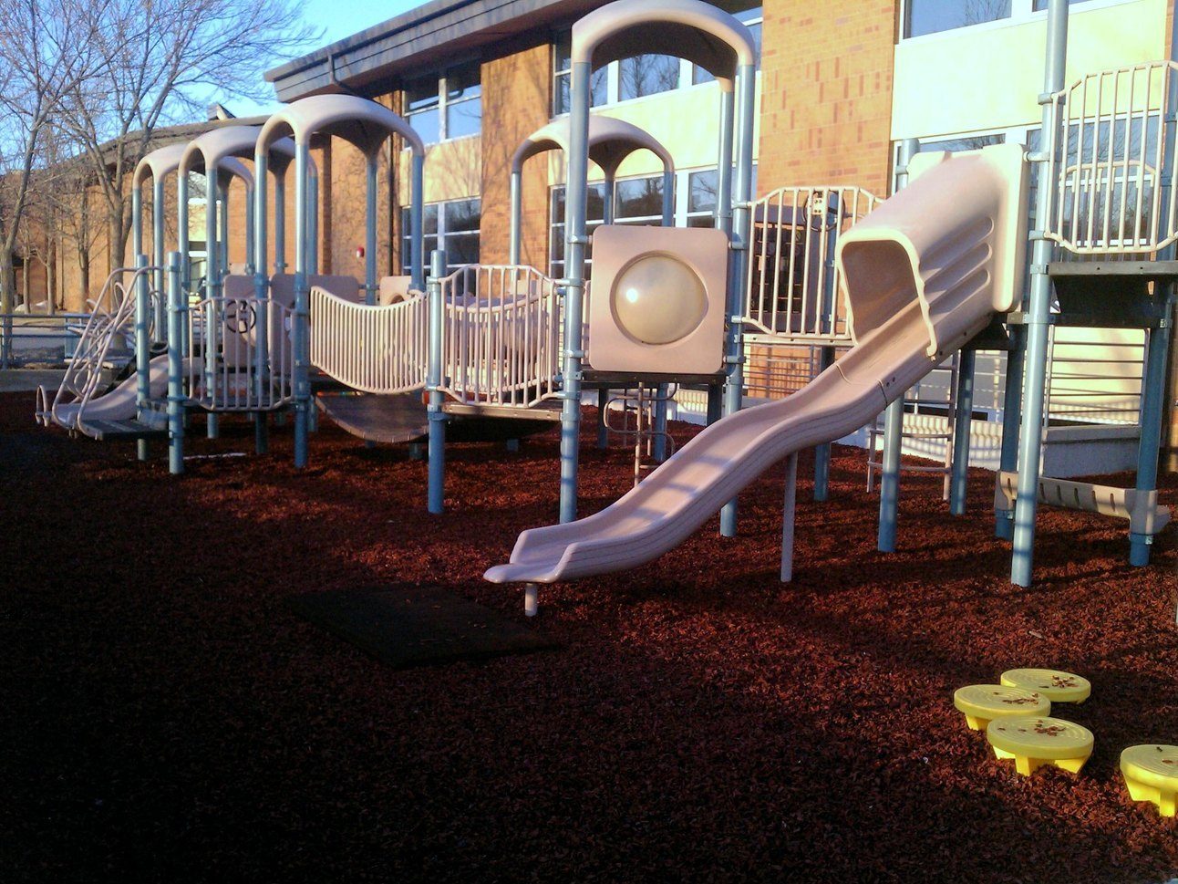 A community-park playground on a rubber mulch fall surface