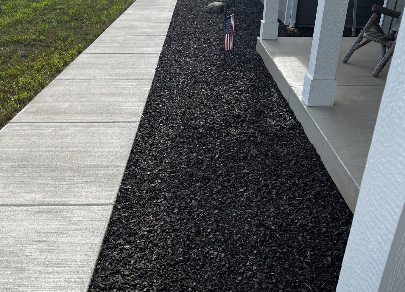 Rubber mulch framing a lush landscape bed
