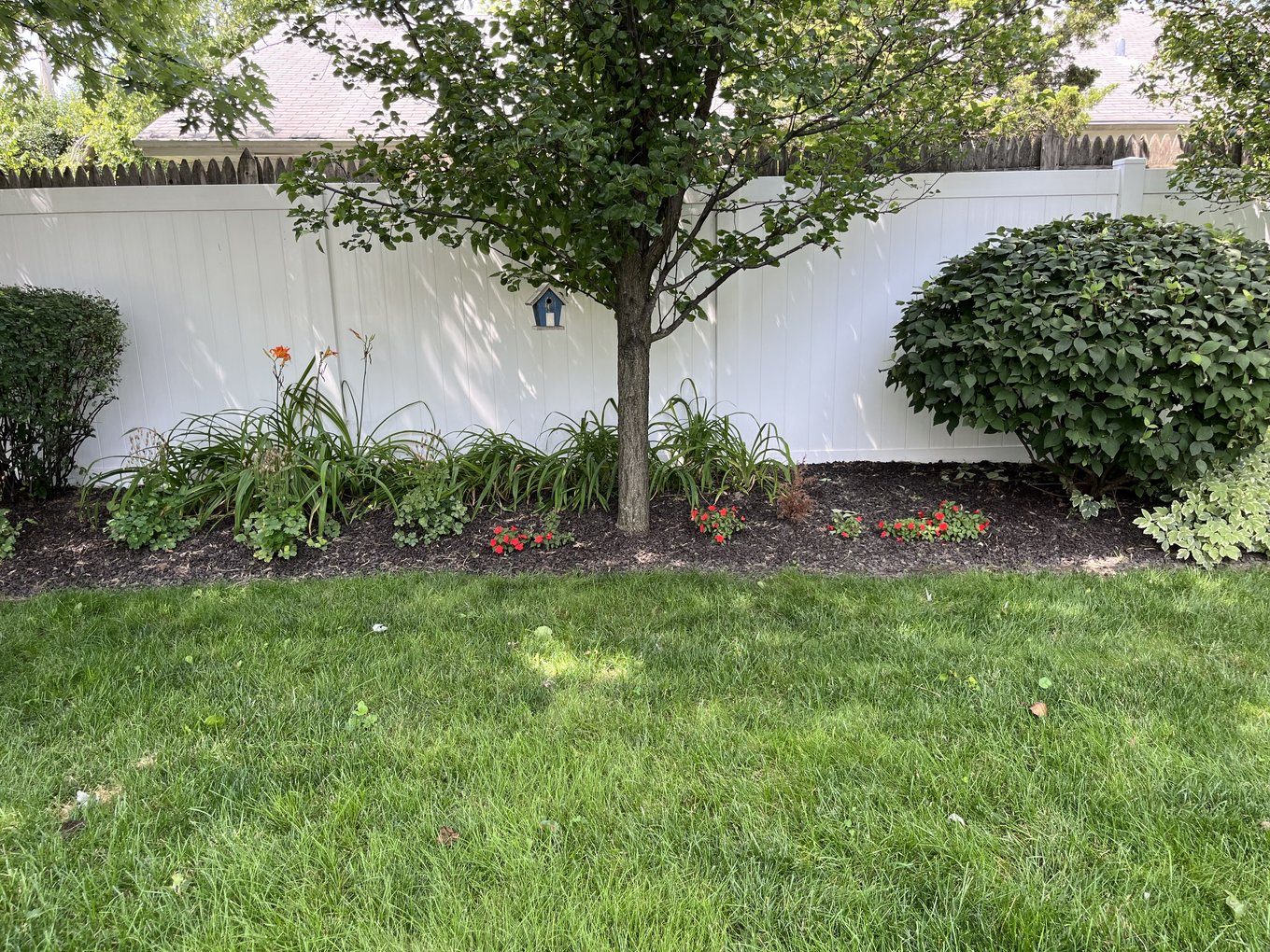 Brown rubber mulch in a landscape bed