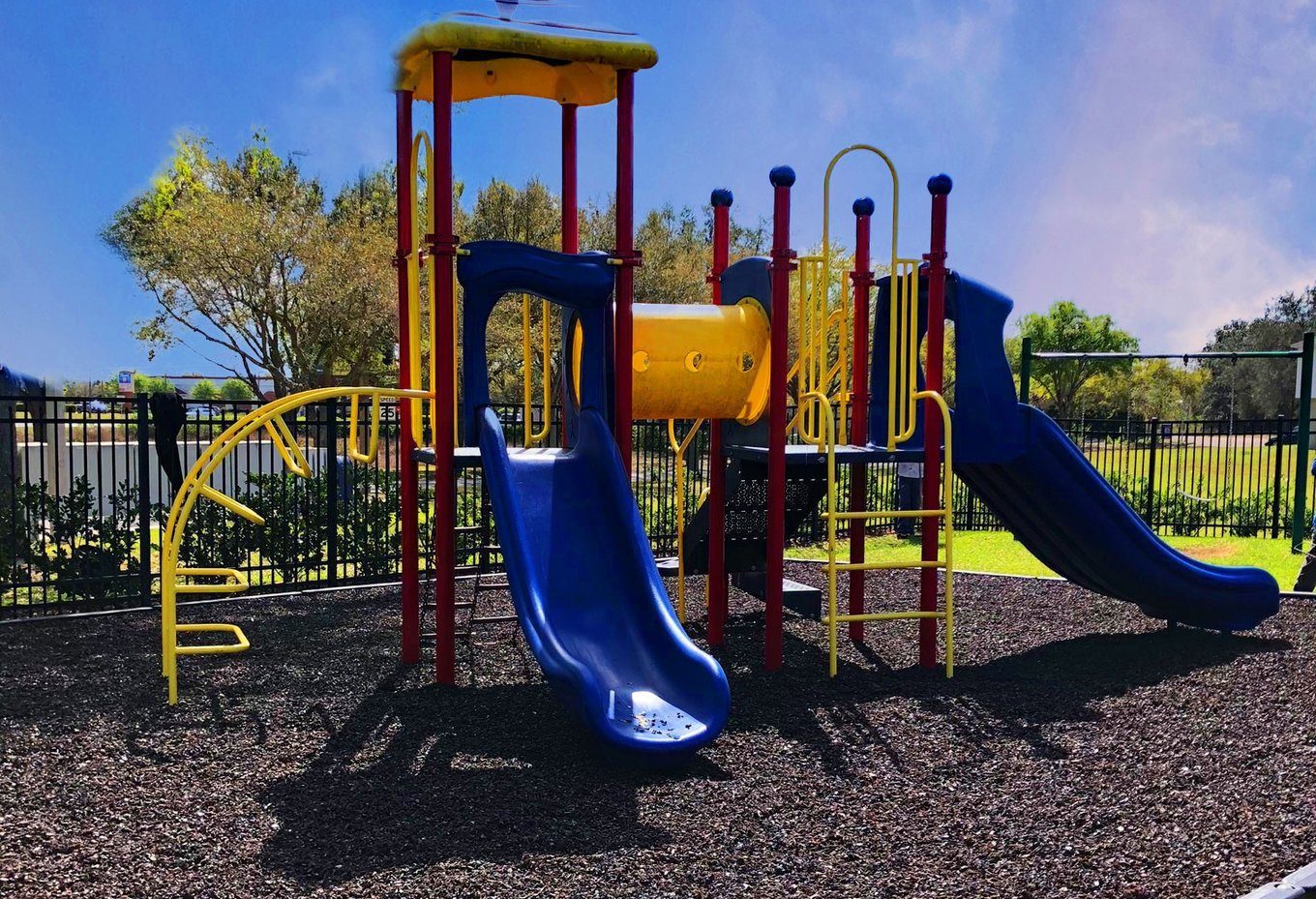 A community-park playground on a rubber mulch fall surface