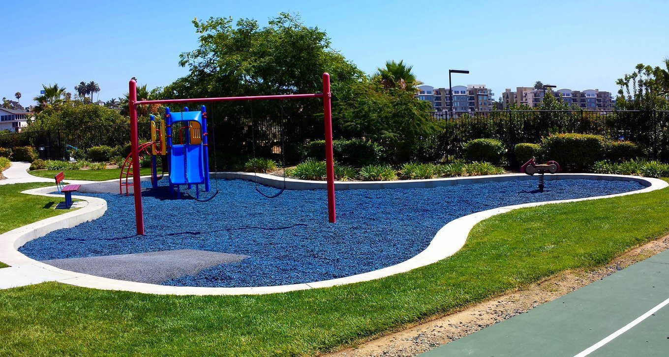 Blue rubber mulch at a park playground