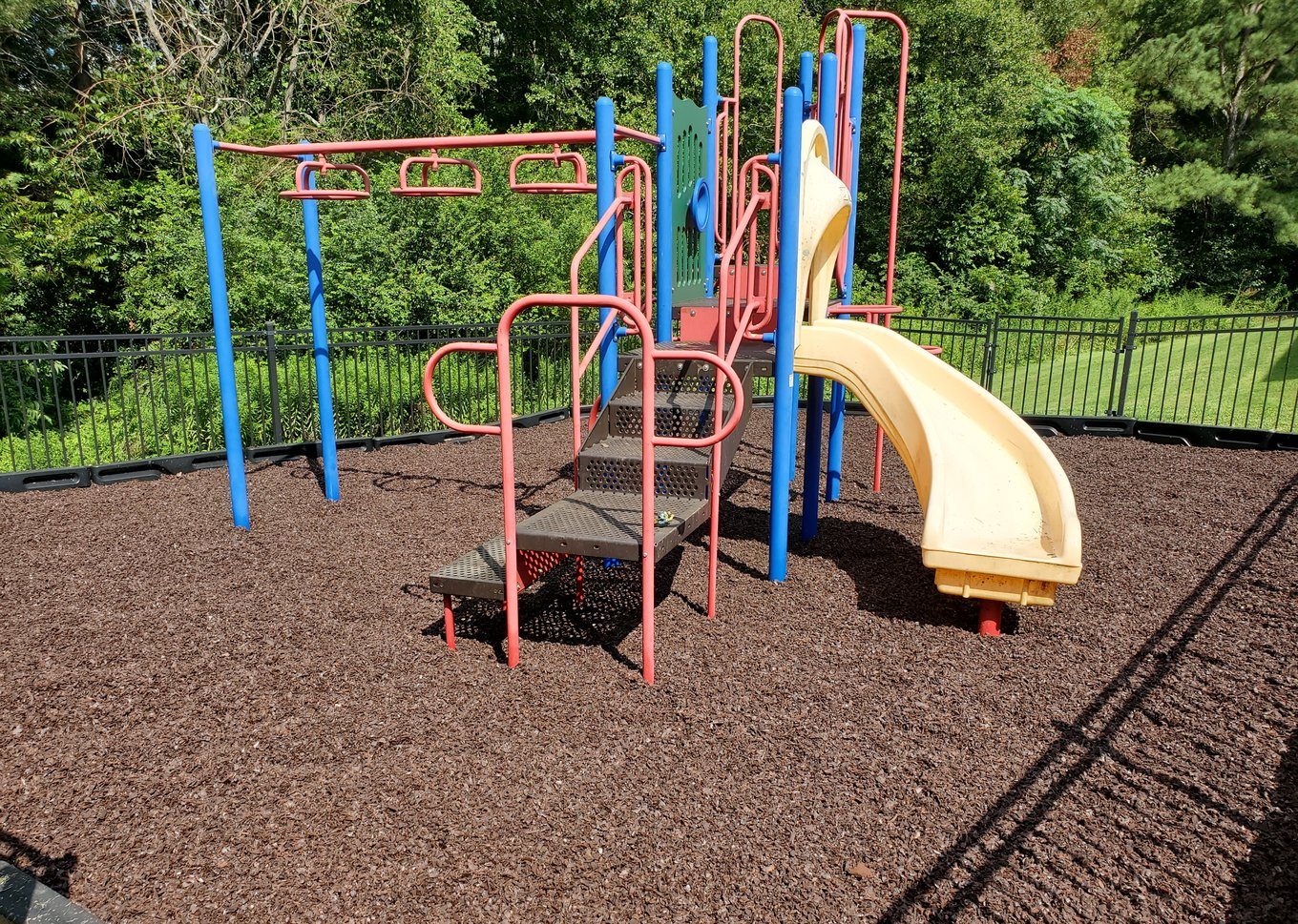 A community-park playground on a rubber mulch fall surface