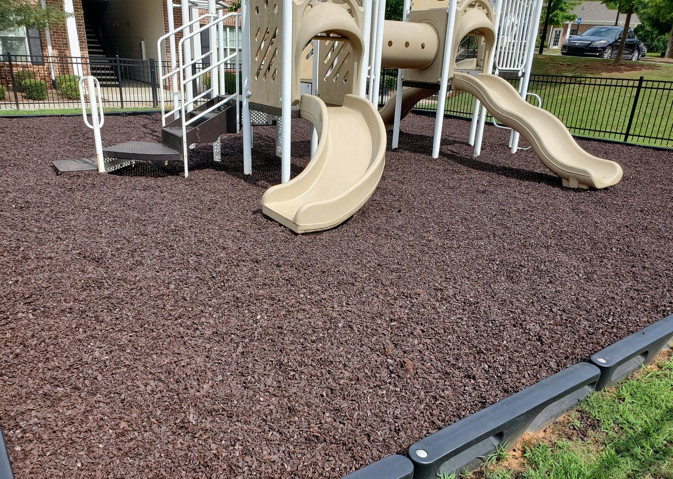 A community-park playground on a rubber mulch fall surface