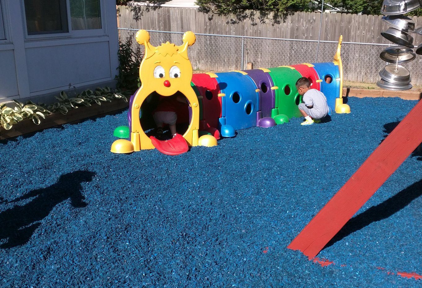 A community-park playground on a rubber mulch fall surface